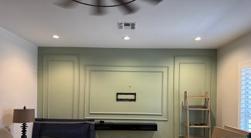 Living-room wall prepared for a 77-inch LG OLED television mount